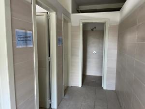 a hallway with a door in a room with a tile floor at Mecca Club in Ischitella