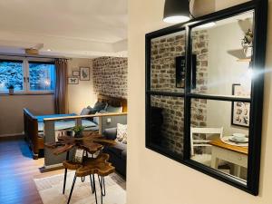 a living room and a dining room with a mirror at Ferienwohnung Palatina in Heuchelheim-Klingen