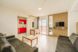 a living room with a couch and a table at Apartamentos El Faro By Mc in Benidorm