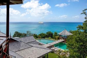 an aerial view of a swimming pool and the ocean at Amazing 6 BR Ocen View Villa in Marigot Bay in Marigot Bay