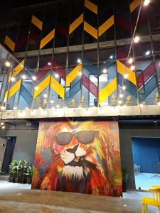 a large painting of a lion with sunglasses at Coliwo Trois - Kharadi in Pune