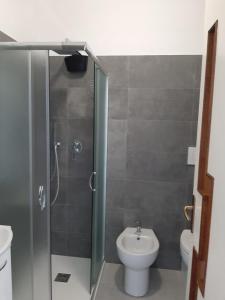 a bathroom with a shower with a toilet and a sink at APPARTAMENTO con TERRAZZA SUL MARE in Santa Marinella