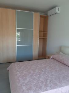 a bedroom with a bed and a sliding glass door at APPARTAMENTO con TERRAZZA SUL MARE in Santa Marinella +7 photos