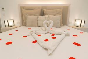 a bedroom with a bed with hearts on it at HOTEL BARONE DI MARE in Torre dell'Orso