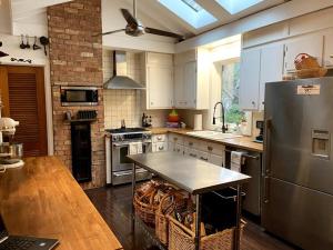 a kitchen with a stainless steel refrigerator and a table at Modern Farmhouse Escape in Matthews