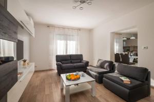 a living room with a couch and a table at Magnolia by Briskva in Vinež +22 photos