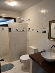 a bathroom with a toilet and a sink at CASA MAR DOCE LAR GOSTOSO - A 150M DA PRAIA in São Miguel do Gostoso