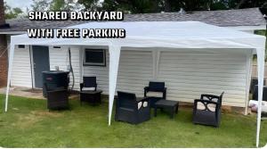 a white tent with chairs under it in a yard at Atlanta Hartsfield International Connection in Atlanta