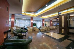a large lobby with couches and chairs in a building at Hotel Iceberg Borovets in Borovets