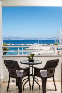 a table and chairs with a view of the ocean at Zephyros Hotel in Kos Town