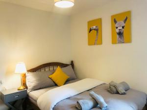 a bedroom with a bed with two stuffed animals on it at Spacious City Centre flat free parking& superfast WIFI in Edinburgh