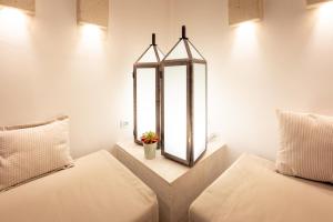 a room with two beds and a mirror at HOTEL BARONE DI MARE in Torre dell'Orso