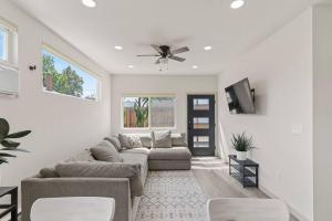 a living room with a couch and a ceiling fan at Beautiful Denver Carriage House in Denver