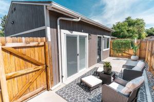 a backyard patio with a wooden gate and a fence at Beautiful Denver Carriage House in Denver