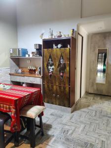 a kitchen with a table and a cabinet with a red table cloth at Your Place in Florida