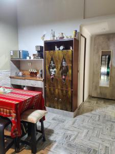 a kitchen with a table and a cabinet with a red table cloth at Your Place in Florida +4 photos