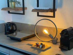 a kitchen counter with a lamp on a table at Theatre Brno Apartments in Brno