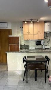 a kitchen with a table and chairs and a counter at apartamento benalmadena in Benalmádena