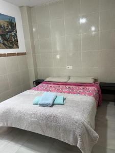a bedroom with a bed with two towels on it at apartamento benalmadena in Benalmádena