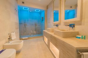 a bathroom with two sinks and a shower at HOTEL BARONE DI MARE in Torre dell'Orso