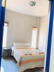 a bedroom with a bed and two windows at Áncora Beach Hotel in Máncora +9 photos