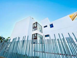 a white building with a fence in front of it at Soul Beach Hotel By Mc - Adults Recommended in Denia