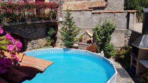 an outdoor swimming pool in a yard with flowers at Casa TEULÉ in Les Iglésies