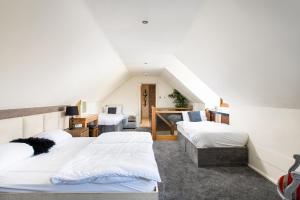 a bedroom with three beds and a desk at The West Barn near Bath, sleeps 24 and 2 hot tubs in Bristol