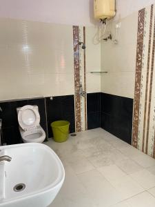 a bathroom with a sink and a toilet at KP Suites Gachibowli in Hyderabad