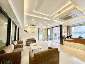 a lobby with a couch and chairs and a table at Hotel Rudraksh ! Varanasi ! fully-Air-Conditioned hotel at prime location with Parking availability, near Kashi Vishwanath Temple, and Ganga ghat in Varanasi