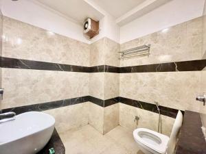 a bathroom with a sink and a toilet at Hotel Rudraksh ! Varanasi ! fully-Air-Conditioned hotel at prime location with Parking availability, near Kashi Vishwanath Temple, and Ganga ghat in Varanasi