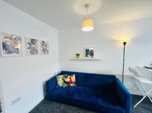 a living room with a blue couch and a table at Chic 1Bed Apt with Transport Links in Liverpool