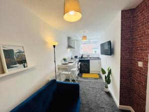 a room with a kitchen with a table and a counter at Chic 1Bed Apt with Transport Links in Liverpool