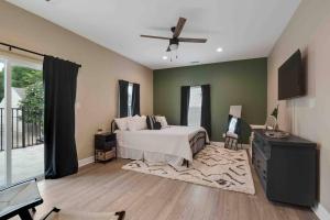 a bedroom with a bed and a ceiling fan at Memphis Midtown Oasis in the heart of Midtown! in Memphis