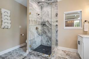 a shower with a glass door in a bathroom at Memphis Midtown Oasis in the heart of Midtown! in Memphis