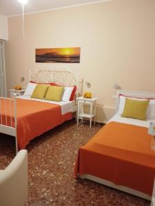 a bedroom with two beds and a table at Casa Blanca in San Vito lo Capo