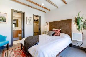 デンバーにあるUnique Denver Designer Home 4 Bed 4 bathのベッドルーム(大型ベッド1台、青い椅子付)