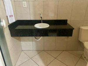 a bathroom with a sink and a toilet at Hotel Jovilá in Jaraguá do Sul +17 photos