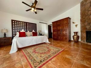 a bedroom with a bed and a ceiling fan at Rancho Las Cruces in Las Cruces