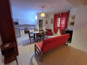 a living room with a red couch and a table at Casa Dolce Casa in Enna