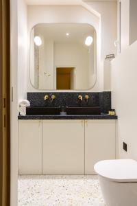 a bathroom with a sink and a mirror at Bourse Feydeau in Paris