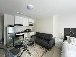 a living room with a glass table and a couch at The Millennial Umhlanga in Durban