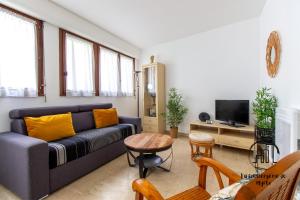 a living room with a couch and a table at Au cœur des Lices in Albi