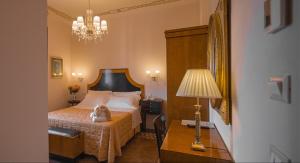 Postel nebo postele na pokoji v ubytování Lucca in Azzurro Maison de Charme