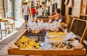 a market with various types of food on a street at A&A B&B Bari in Bari