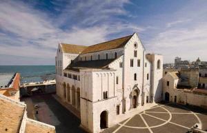 a large white building next to the ocean at A&A B&B Bari in Bari
