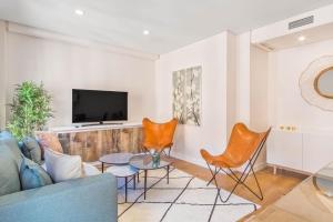 MALDONADO I في مدريد: غرفة معيشة مع أريكة وكراسي وتلفزيون