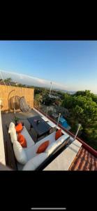 a balcony with a couch and a table on a roof at Pool Rooftop Kadikoy Bagdat St. Seaside metro 5mins Metro in Istanbul