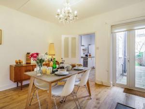 a kitchen and dining room with a table and chairs at 4 Bed in Holt 87148 in Holt