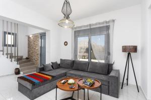 a living room with a couch and a table at Villa Livis 2 in Kiotari